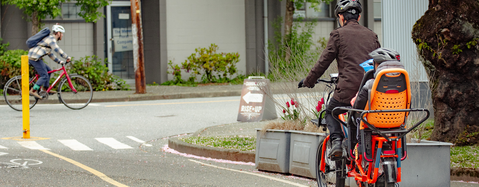 A father and his children cycle on a bike lane in Vancouver.