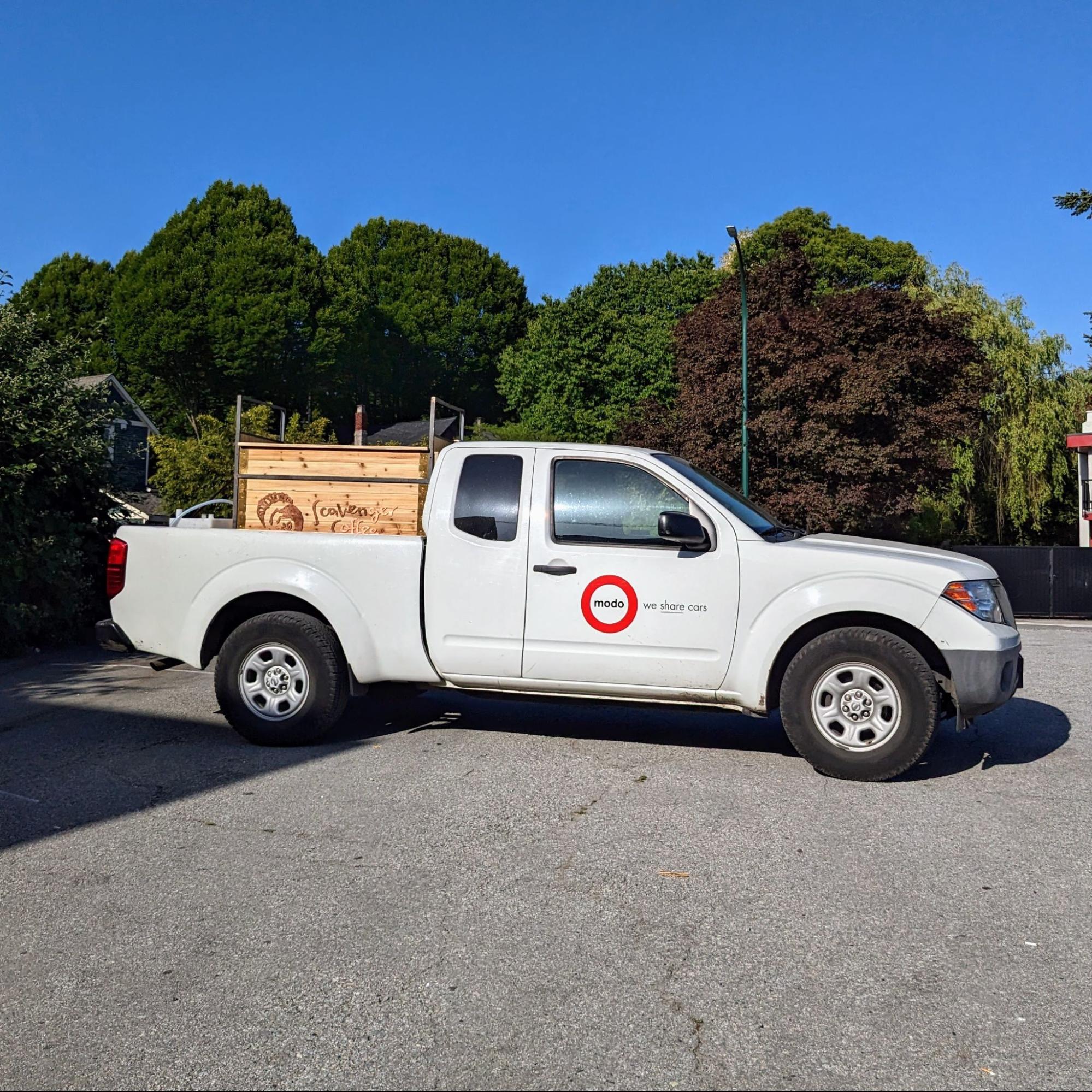 Modo's Nissan pickup truck with the mobile coffee cart in the trunk.