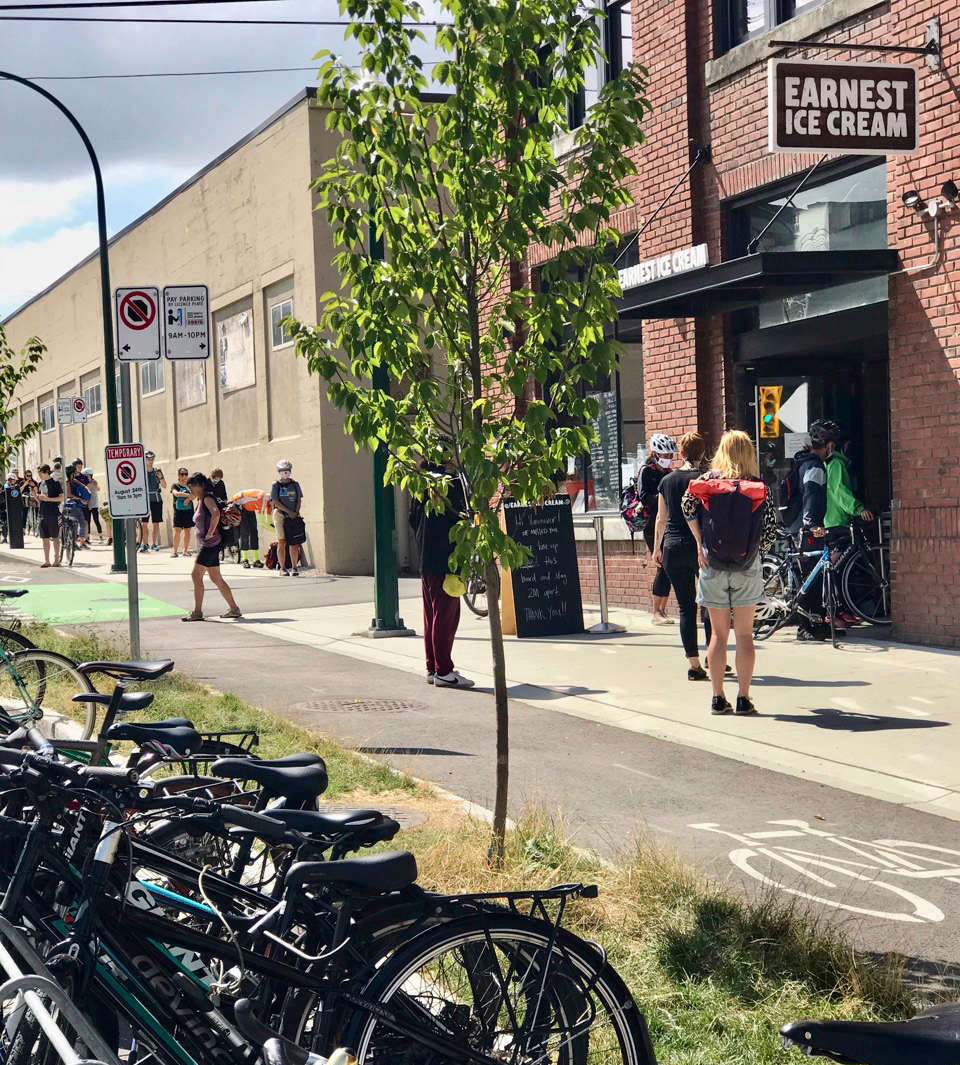 People wait in line outside Earnest Ice Cream to redeem their free ice cream as part of Bike to Shop.