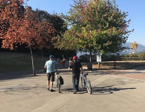 Two people with bikes at Stanley Park Seawall